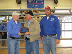 Steve Williams of J & W receiving his plaque for their consignment J&W Mr Cruising that was the winner of the FL Bull Test and SimAngus breed winner. Pictured (from L to R): Nick Comerford (NFREC Center Director), Steve Williams, and David Thomas (NFREC Beef Unit Supervisor).